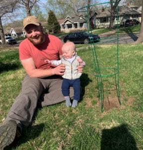 MTN staff member and son with dogwood sapling