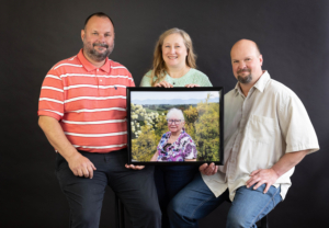 Photo of Regeina Brazeal's family holding her portrait.
