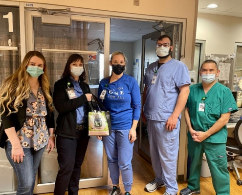 Group photo of hospital staff holding a NDLM goodie bag.