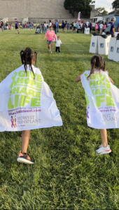 Photo of two little girls wearing Give Hope, Share Life capes.