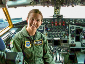An Air Force pilot sitting in the cockpit of a military aircraft.