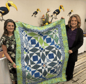 Linda Isaac with quilt made for her by a volunteer
